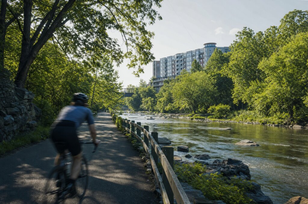 Cyclist riding along the Saw Mill River Greenway trail